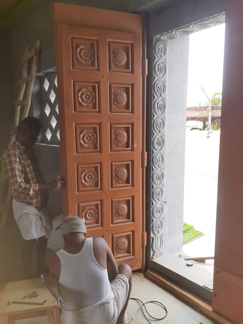Installation team fitting a finished door